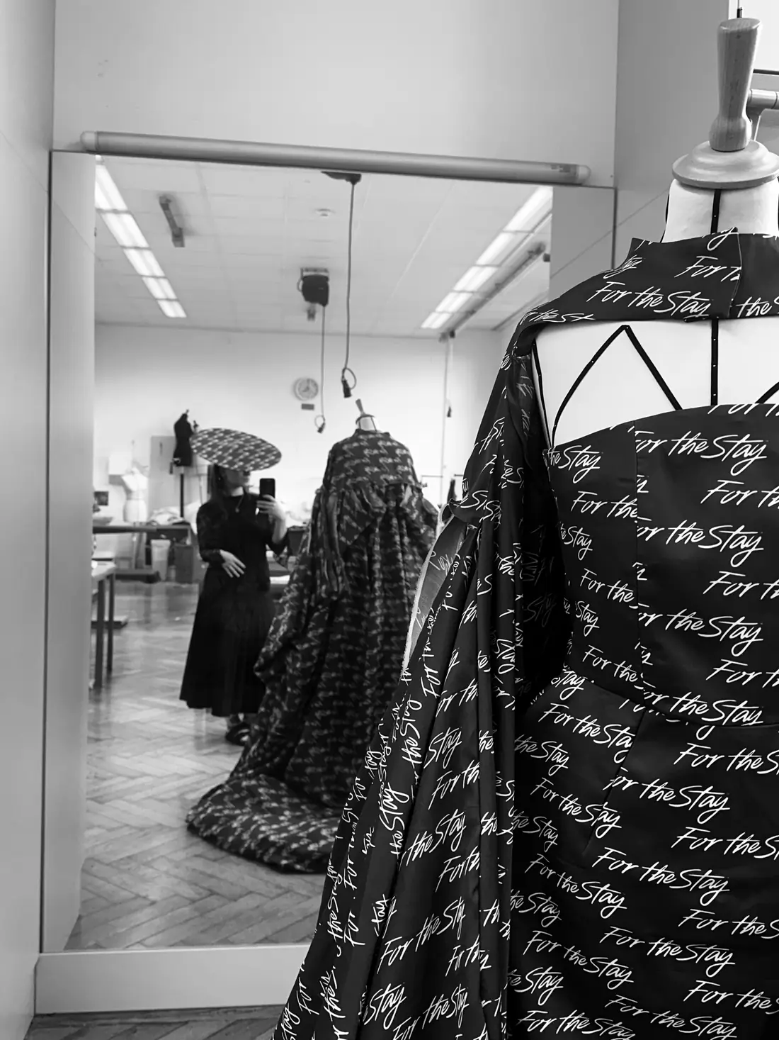 Making of: the dress on a dress form in the atelier, a mirror behind it.
